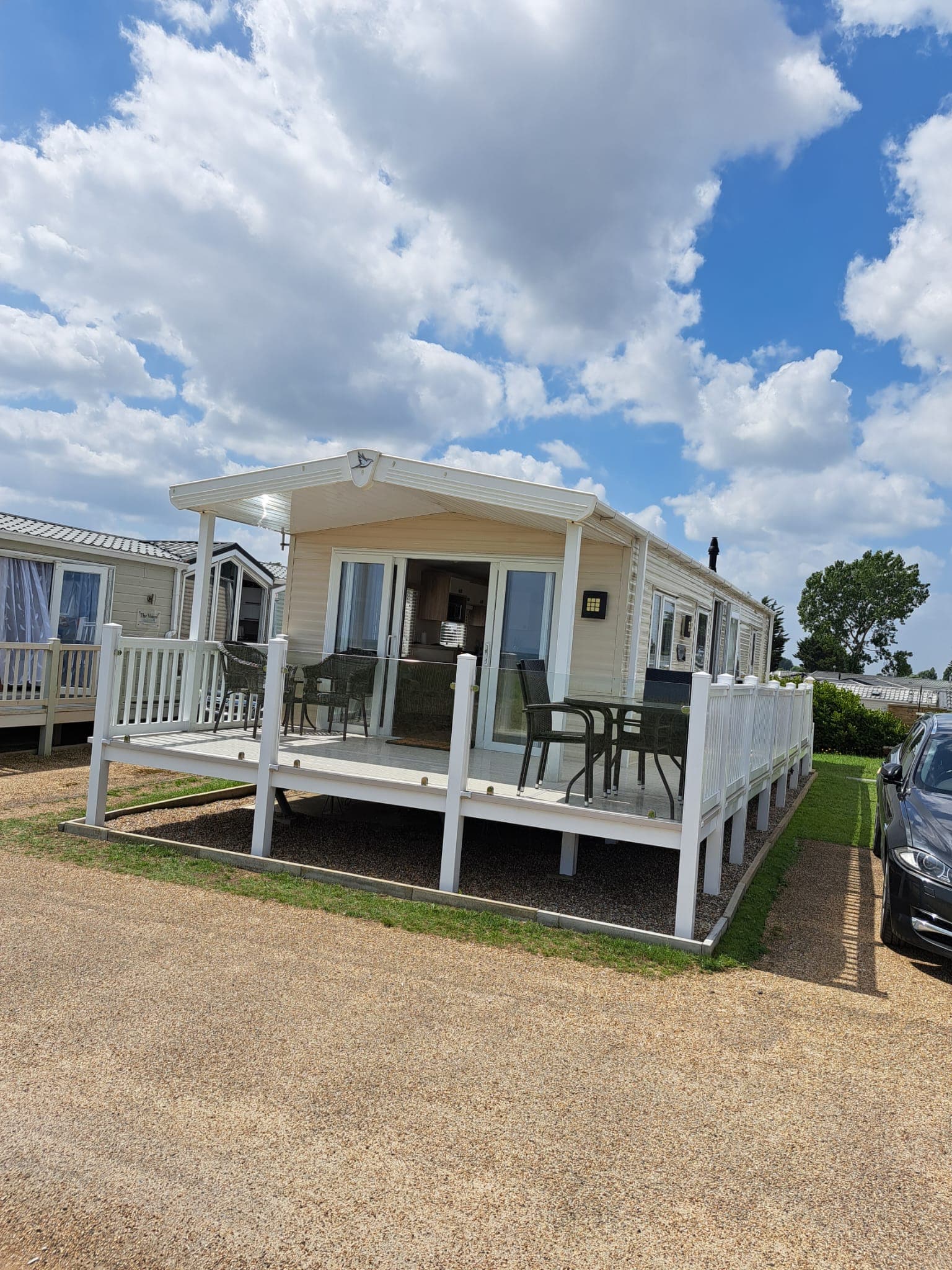 The caravan from the front, with its private decking and off-street parking